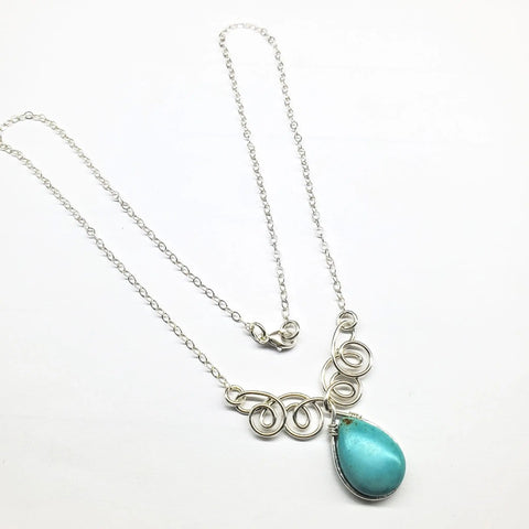 The Alexa Martha Designs As Seen on TV Turquoise Drop Sterling Silver Wire Wrapped Necklace features a large teardrop turquoise pendant with ornate swirls, beautifully displayed on a white background—a perfect showcase of handmade craftsmanship.