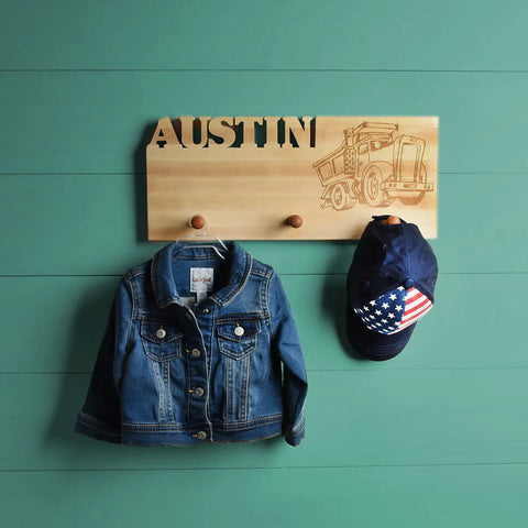 A three pegged American made coat rack with personal custom names etched into it. 