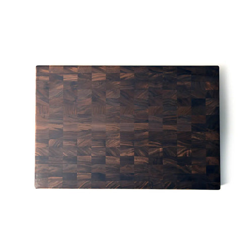 The Handcrafted Wooden Cutting Board by Words with Boards is a rectangular, dark solid walnut end-grain board with a checkered pattern, perfect for chefs and home cooks. Made in the USA, its displayed on a white background.