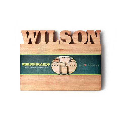 The Handcrafted Wooden Personalized Cutting Board (Small) by Words with Boards features your chosen name, a green WORDS with BOARDS label, and a heart for Baltimore, Maryland—a practical kitchen accessory and unique gift. Made in the USA.