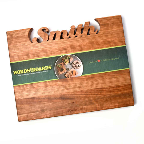 The Handcrafted Wooden Personalized Cutting Board – Large by Words with Boards features “Smith” carved at the top, a food-themed green band around the center, and “April 8, 2023” engraved at the bottom—an ideal kitchen showpiece.