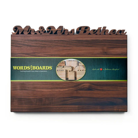 The Handcrafted Wooden Personalized Cutting Boards – Large by Words with Boards features Mr & Mrs Bethea in script on dark American hardwood, a green band with the Words with Boards logo, and Handcrafted in Baltimore, Maryland with a red heart.