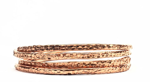 The Alexa Martha Designs 2 Piece Handmade Interlocking Full Overlap Copper Bangle Set features two textured copper bangles with an overlapping design, displayed against a plain white background.