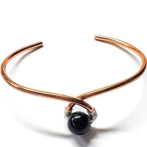 The Alexa Martha Designs Handmade Copper Silver Ribbon Child Abuse Awareness Teardrop Bangle features a unique teardrop shape with copper and silver accents, designed to promote awareness and handcrafted with attention to detail.