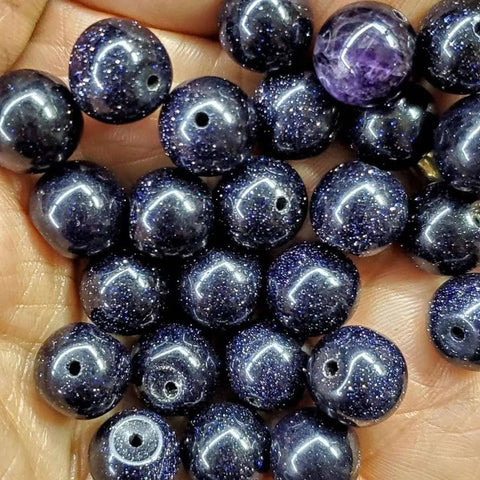 A close-up of a hand holding the Handmade Copper Silver Ribbon Child Abuse Awareness Teardrop Bangle by Alexa Martha Designs—perfect for showcasing its sparkling details and unique craftsmanship.