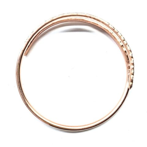 The Full Overlap Copper Bangle by Alexa Martha Designs is a handmade rose gold bracelet with a spiral design, partially open at one end and shown on a white background.