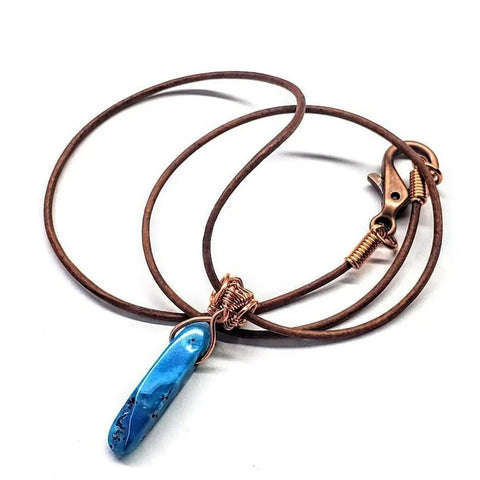 The Wire Wrapped Pointed Turquoise Agate Leather Necklace for Him and Her by Alexa Martha Designs features a wire wrapped gemstone pendant with lobster clasp, showcased on a white background.