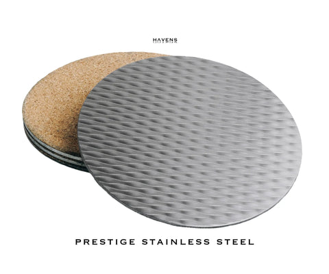 A round, textured Drink Coaster - Stainless Steel by Havens Luxury Metals is displayed before a stack of matching coasters with cork backing on a white background. Havens appears above; below reads: Prestige Stainless Steel.