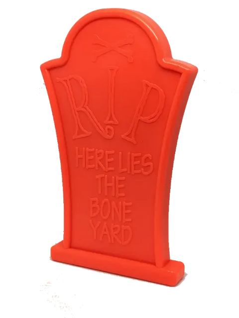 The SodaPup Headstone Ultra Durable Nylon Dog Chew Toy is a bright orange tombstone with RIP and Here Lies the Bone Yard, plus crossed bones—built tough for aggressive chewers.