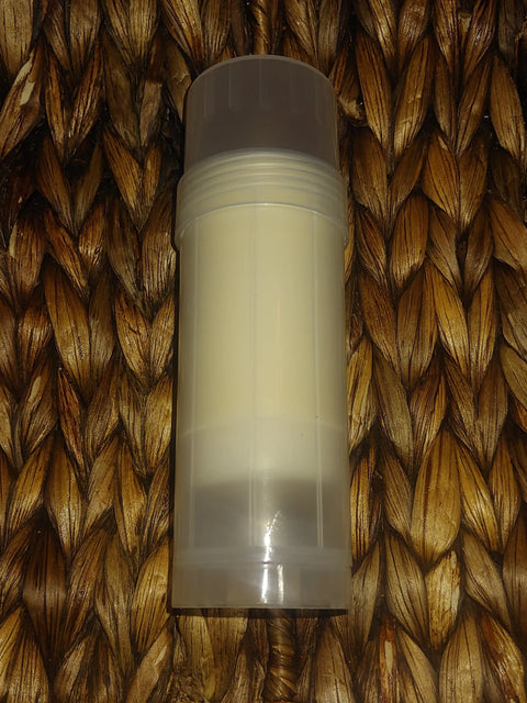 The Bathsheba Body Works Moisture Bar - Love Me, in a clear plastic deodorant stick container with a white inner tube, is ideal for artisan-crafted recipes and shown on a woven brown textured surface.