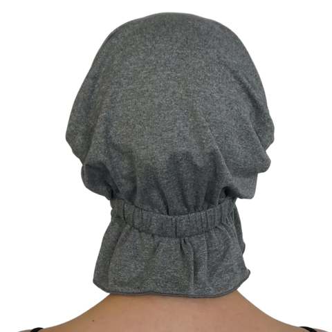 A person is seen from behind wearing the Patricia Chemo Beanie® by Chemo Beanies®. This gray, elasticated beanie extends over the head and neck, with soft, gathered fabric for a comfortable slip-on style.