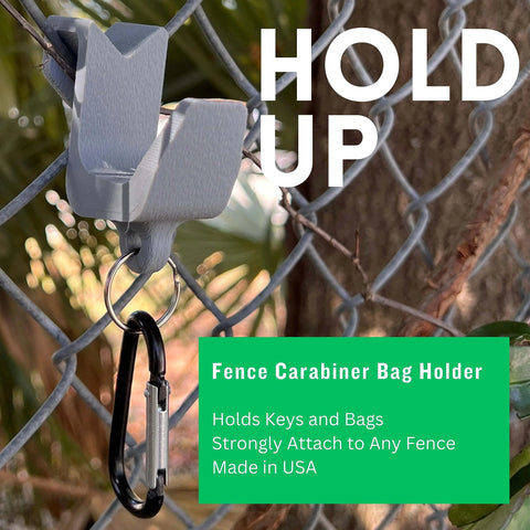 A Carabiner Fence Holder by Chatelet Manufacturing is attached to a chain-link fence, holding a black carabiner with keys. Text: HOLD UP. Holds keys and bags. Strongly attaches to any fence. Made in USA.