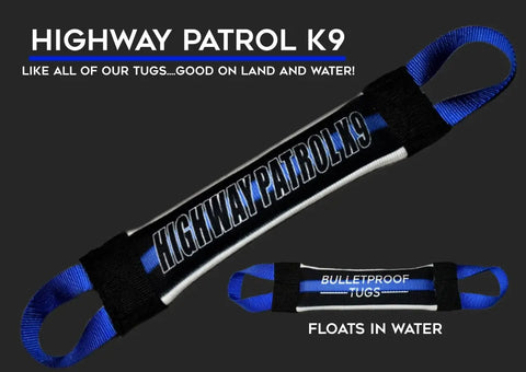 The Highway Patrol K9 Fire Hose Training Tug by Bulletproof Pet Products Inc is a black and blue heavy-duty dog toy with handles at both ends, labeled HIGHWAY PATROL K9. Its bulletproof, floats in water, and perfect for land or water play.