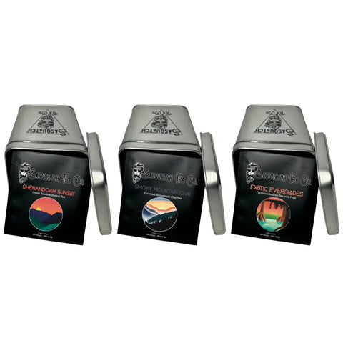 Three Sasquatch Tea Co tins from the Caffeine Free Tea Bundle—Shenandoah Sunset, Smoky Mountain Chai, and Exotic Everglades—are displayed with lids off, each offering a unique caffeine-free and flavorful herbal tea blend.