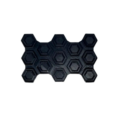 The Chatelet Manufacturing Snowboard Stomp Pad features a black hexagon pattern for superior grip and weatherproof adhesion. Its raised honeycomb design ensures reliable traction, making it ideal for any snowboard.