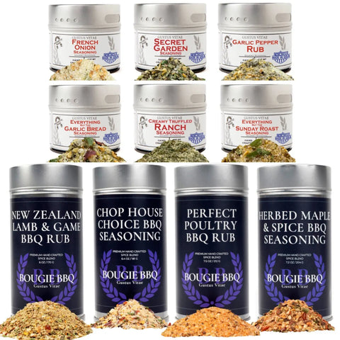 The Gustus Vitae Complete Holiday Mains & Sides Meal Kit displays 10 all-natural gourmet seasonings, including blends like Secret Onion and Garlic Pepper Rub, with larger Bougie BBQ rub tins and seasoning piles in front.