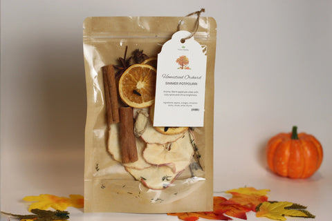 A bag of Forev'Herbs Homestead Orchard Simmer Potpourri, packed with dried apples, orange slices, cinnamon sticks, and spices, brings a cozy farmhouse aroma to your space—ideal for autumn decor or kitchen freshness.