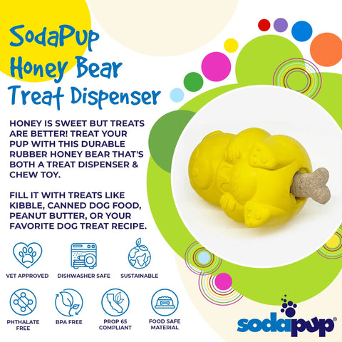 The SodaPup Honey Bear EDispenser is a yellow, durable rubber treat dispenser shaped like a bear, safely holding dog treats in its mouth. Its colorful design and logos make it an enticing and tough chew toy for dogs.