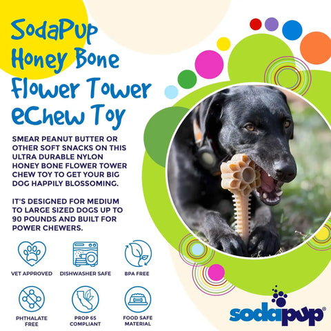 A black dog chews on the tan SodaPup Honey Bone Dental Flower Tower EChew Ultra Durable Nylon Dog Chew Toy - XL outdoors. Dishwasher safe, BPA free, this dental toy is perfect for large dogs.