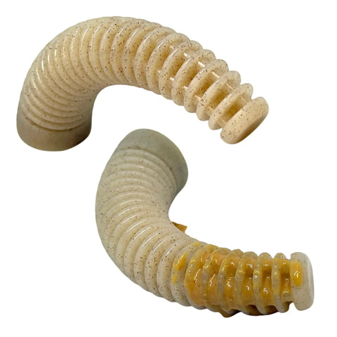 Two curved, beige SodaPup Honey Bone Dental Antler EChew Ultra Durable Nylon Dog Chew Toys (XL) for power chewers; one features a shiny yellowish coating on its ridged surface.