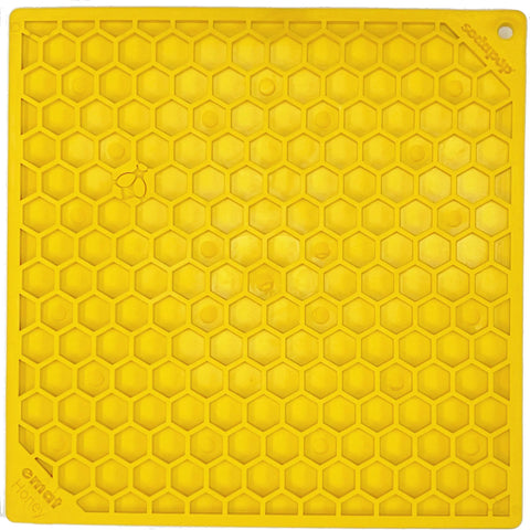 The SodaPup Honeycomb Design Emat Enrichment Lick Mat is a bright yellow, square silicone mat with a raised hexagonal pattern and corner hole for hanging—ideal for dog enrichment.