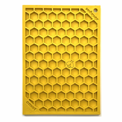The SodaPup Honeycomb Design Emat Enrichment Lick Mat is a yellow rectangular mat featuring a hexagonal pattern, central bee illustration, and embossed “emoi honey” and “Sweet Joy”—an ideal enrichment toy for dogs.