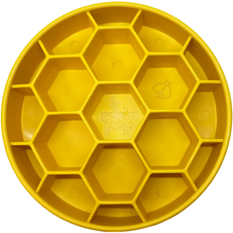 The SodaPup Honeycomb Design EBowl Enrichment Slow Feeder Bowl for Dogs is a round, yellow silicone tray with hexagonal sections and a honeycomb pattern—perfect for slowing your dogs eating. Features the SodaPup logo at the center and a bee icon in one cell.
