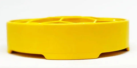 The SodaPup Honeycomb Design EBowl Enrichment Slow Feeder Bowl for Dogs is a bright yellow, shallow, round plastic bowl with a raised grid pattern that promotes slower eating, shown against a plain white background.