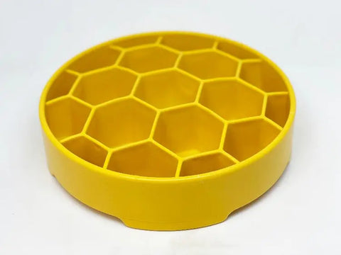 The SodaPup Honeycomb Design EBowl Enrichment Slow Feeder Bowl for Dogs is a round, yellow plastic bowl with hexagonal compartments, shown from a slight angle on a white background.