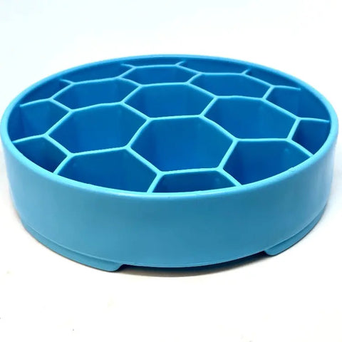 A blue, round SodaPup Honeycomb Design EBowl Enrichment Slow Feeder Bowl for Dogs with hexagonal compartments is shown at an angle against a white background.