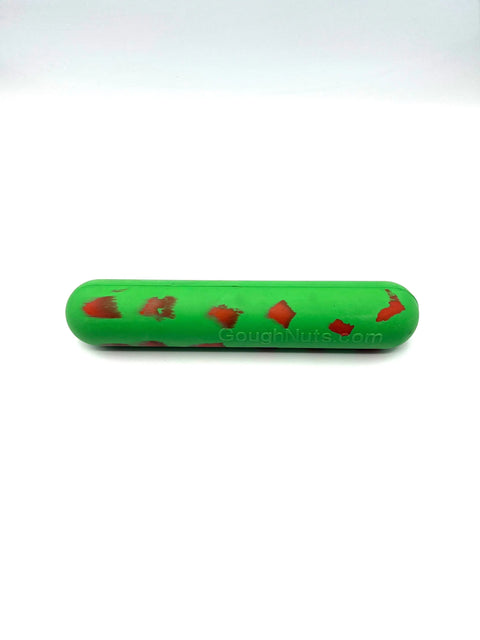 The Goughnuts Green Stick, a durable green cylindrical chew toy with red marks and rounded ends, is designed for small-breed dogs. Shown on a white background. Enjoy peace of mind with the Goughnuts Guarantee.