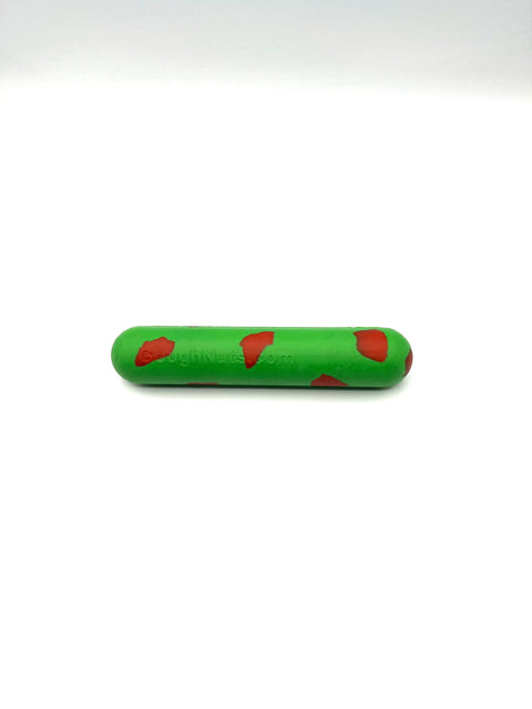 The Goughnuts Green Stick, a durable dog toy with irregular red patches, lies horizontally on a plain white background.
