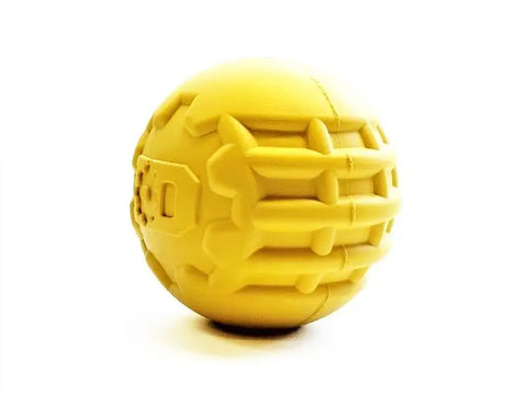 The SodaPup ID Ball Durable Rubber Chew Ball is a bright yellow, natural rubber toy for power chewers, with textured geometric patterns and dental ridges, shown on a plain white background.