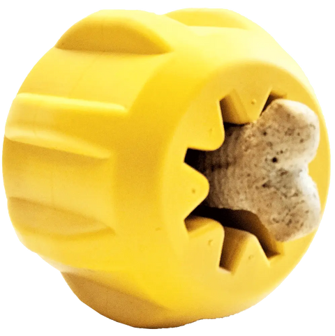 The SodaPup Gear EDispener is a yellow, round, durable rubber chew toy with deep grooves and a star-shaped opening that holds a bone-shaped treat—ideal as a dental chew for power chewers.