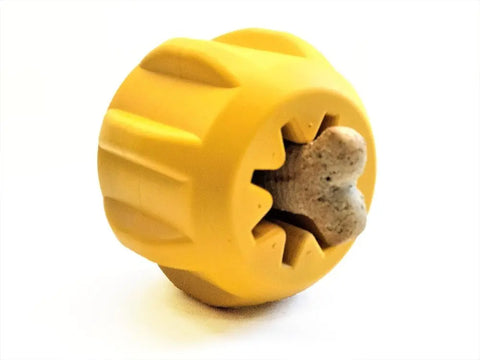 The SodaPup Gear EDispener Durable Rubber Treat Holder and Chew Toy is a yellow, round, textured toy that securely holds treats in its star-shaped opening, perfect for keeping active power chewers engaged as they play.