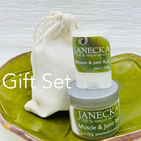 A green ceramic dish displays two JANECKA Muscle & Joint Rub containers and a beige drawstring pouch, showcasing Janecka Skincare’s natural organic skincare and herbal pain relief. “Gift Set” is written on the image.