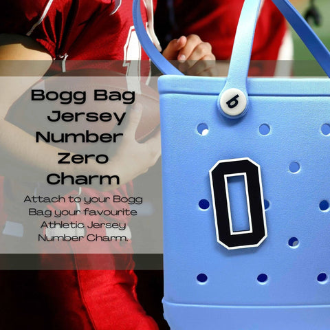 A close-up of a blue Bogg Bag features a black and white Chatelet Manufacturing BOGLETS - Jersey Sports Uniform T-Shirt Number charm. In the background, someone in a red football jersey holds a football. Text promotes personalized tote bag accessories.