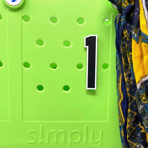 A vivid green BOGLETS - Jersey Sports Uniform T-Shirt Number from Chatelet Manufacturing, embossed with simply, features round holes, a black-and-white 1 sticker, and a hint of colorful fabric—ideal for displaying bag or charm accessories.