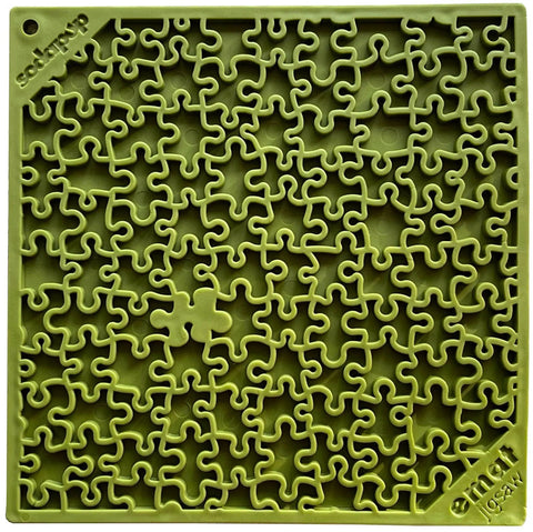 The SodaPup Jigsaw Design EMat Enrichment Lick Mat is a square green silicone dog toy with a maze-like pattern and an abstract missing piece near the bottom left. Embossed text marks the corners, adding to its unique design.