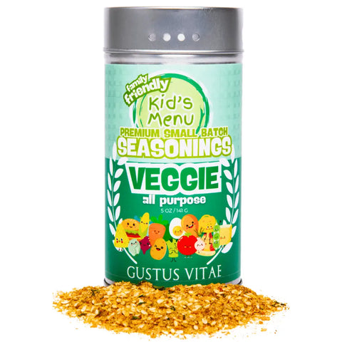 A container of Gustus Vitae Kid’s Menu: Veggie: All Purpose Seasoning, featuring playful veggie cartoons on the label, sits with some yellow seasoning spilled in front. Made with non-GMO ingredients.