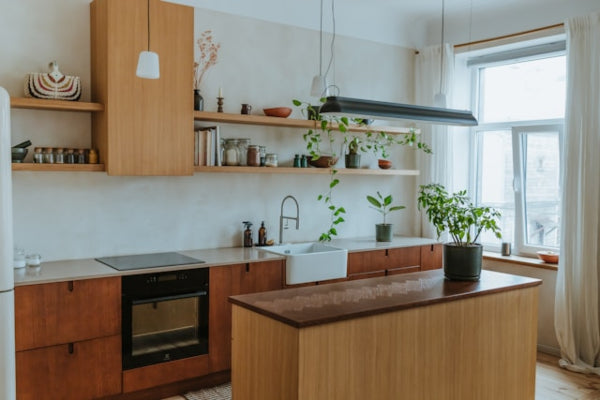 Modern kitchen with wooden cabinets, island, and white appliances.
