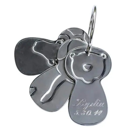 Kleynimals – Clean Key Animals® by Kleynimals features shiny, silver-colored stainless steel toy keys shaped like bears on a ring. One bear has engraved text on its body.