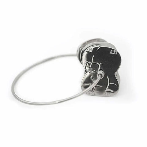 The Kleynimals Stainless Steel Rattle by Kleynimals is a silver metal keyring with a bear-shaped charm, featuring simple engraved details. Non-toxic and safe for babies, it makes a charming keepsake. Shown on a softly focused white background.