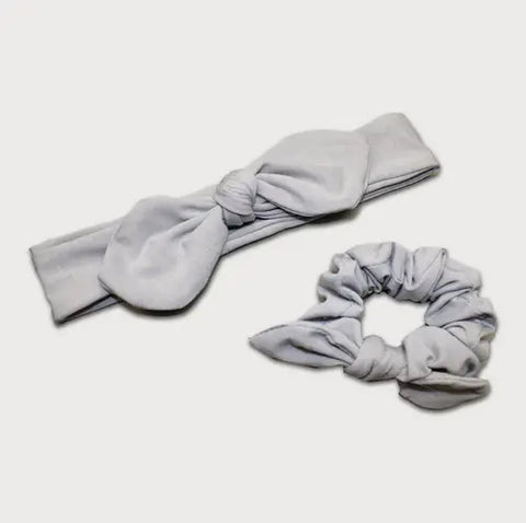 The Goodnighties Matching Knotted Bow Headband & Scrunchie set in light gray, stylish hair accessories, displayed on a white background.