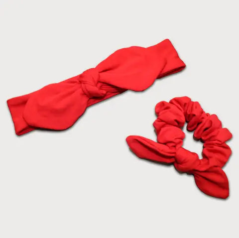 The Goodnighties Matching Knotted Bow Headband & Scrunchie set in red features a stylish knotted headband and a matching small-bow scrunchie—perfect accessories to complement any look.