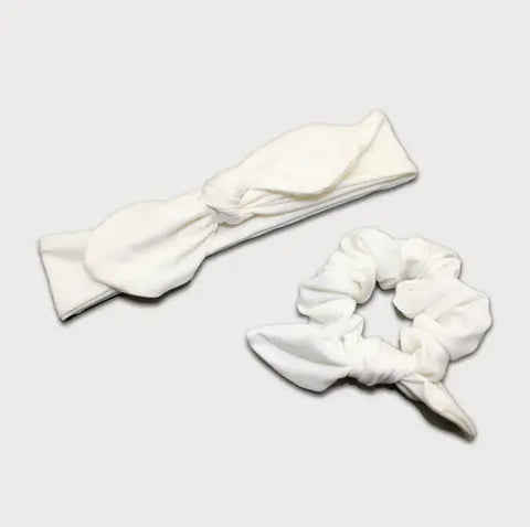 The Goodnighties Matching Knotted Bow Headband & Scrunchie set features soft fabric and a coordinating design, shown on a plain light background—stylish hair accessories perfect for any occasion.