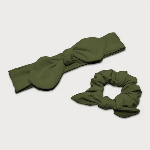 The Goodnighties Matching Knotted Bow Headband & Scrunchie set in olive green features a knotted headband and bow-accented scrunchie, shown on a white background—stylish hair accessories for any outfit.