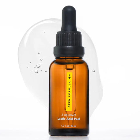 A 1 oz (30 ml) brown glass dropper bottle labeled Open Formula Lactic Acid Peel stands before a clear, bubbly gel smear. This exfoliating peel helps unclog pores for smoother, clearer skin.