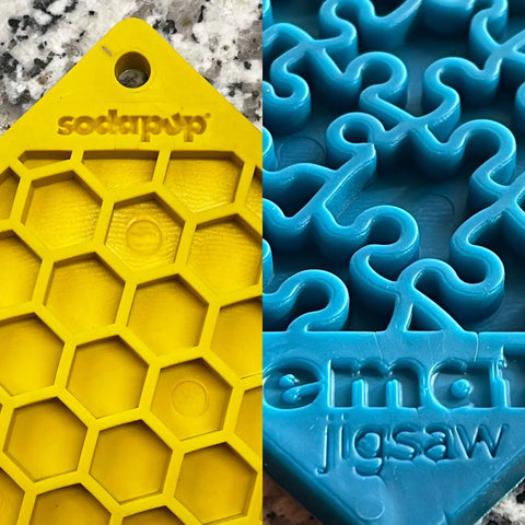 The Large Blue Jigsaw & Large Yellow Honeycomb EMat Lick Mat Bundle by SodaPup features two textured silicone lick mats: a blue jigsaw pattern and a yellow honeycomb design, both shown close up.