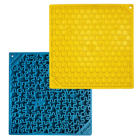 The SodaPup Large Blue Jigsaw & Large Yellow Honeycomb EMat Lick Mat Bundle includes two square mats—blue with a jigsaw design and yellow with a honeycomb pattern—each featuring corner holes, perfect as slow feeder dog accessories.